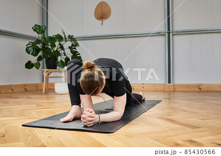 crouched woman with no recognizable face practicing yoga crouched woman with no recognizable face practicing yoga 85430566