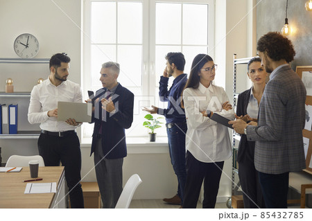 Busy day. Group of office workers work and solve various issues in a modern coworking center. Every employee of the office has a task to make the project successful. Concept of teamwork on the project 85432785