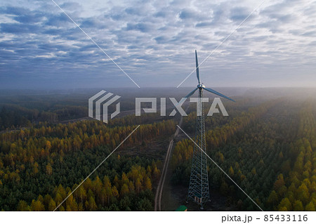 Windmill with a fixed propeller in the countryside against the background of the dawn sky. Windmill with a fixed propeller in the countryside against the background of the dawn sky. 85433116