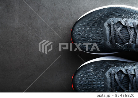 Black sports sneakers for training on a dark background Black sports sneakers for training on a dark background 85436820