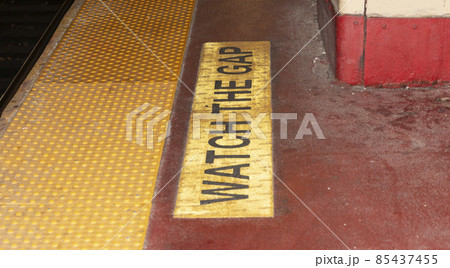 Watch the gap written on platform of train station 85437455