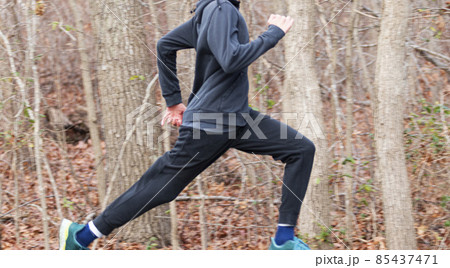 Fast runner running in the woods with a blurred background 85437471