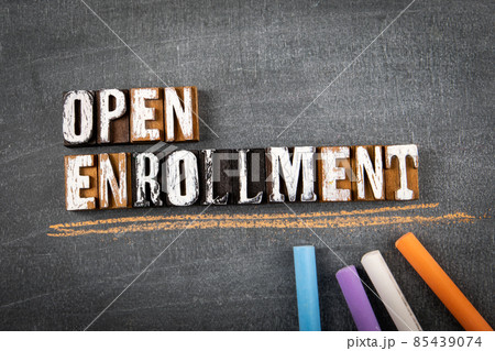 Open Enrollment. Word on a dark chalk board 85439074