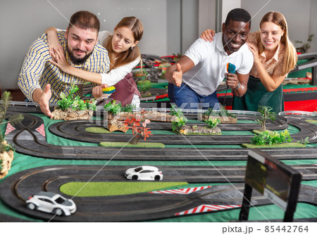 Girls with guys play slot car racing models 85442764