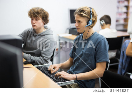 Schoolboy and schoolgirl working with computers in class room 85442827