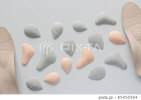 The process of manufacturing individual orthopedic insoles for people with foot diseases, flat feet. Close-up of the insole and accessories for it. The process of manufacturing individual orthopedic insoles for people with foot diseases, flat feet. Close-up of the insole and accessories for it. 85450504