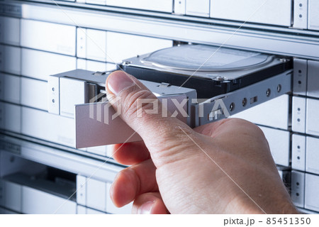hand of a technician swapping hard drive with SAS interface insi hand of a technician swapping hard drive with SAS interface insi 85451350