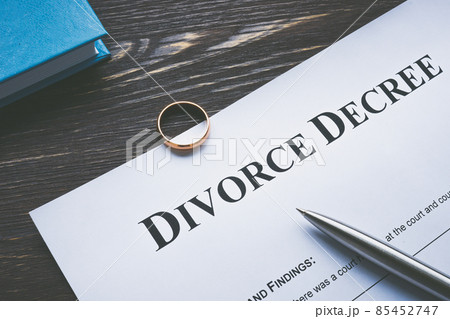 Divorce degree for signing and a wedding ring. 85452747