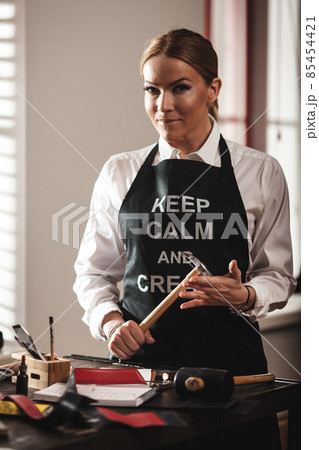 Leather handbag craftsman at work in a vintage workshop. Small business concept 85454421