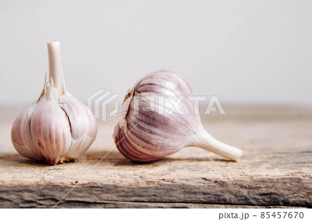 Garlic lie in a row on a rustic wooden background. Copy, empty space for text 85457670