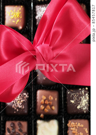 chocolate candies box and red bow 85457817