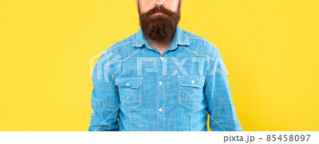 Bearded mustached man crop view in denim shirt yellow background, beard 85458097