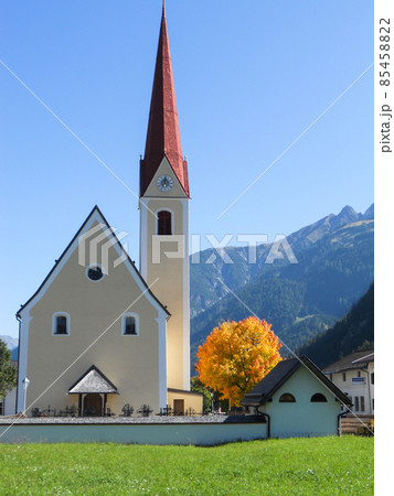 Zell am Ziller, Tyrol, Austria. September 2012. The church of Zell am Ziller with a golden autumn tree, Tyrol, Austria. Zell am Ziller, Tyrol, Austria. September 2012. The church of Zell am Ziller with a golden autumn tree, Tyrol, Austria. 85458822