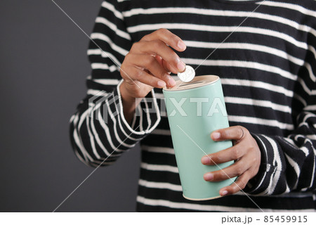 young man saving coins in a jar white sited young man saving coins in a jar white sited 85459915