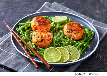 Prawn and Crab Cakes on a plate with green beans 85460669