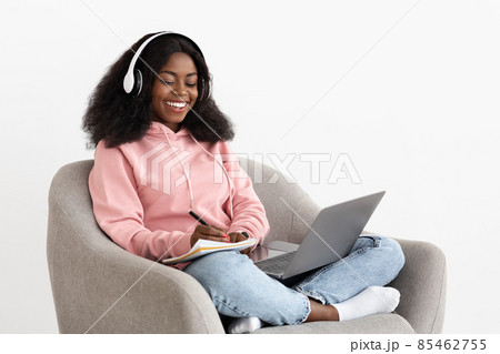 Positive black woman attending webinar, using laptop and headset 85462755