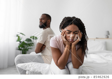 Sad offended millennial african american wife ignores upset husband after quarrel on bed 85462926