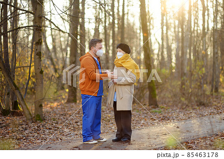 Nurse or volunteer looks after an elderly lady patient while walking in park. Caring for sick person. Boarding houses for the elderly. Nursing home. Professional nurses. Nurse or volunteer looks after an elderly lady patient while walking in park. Caring for sick person. Boarding houses for the elderly. Nursing home. Professional nurses. 85463178