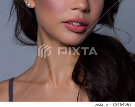 Close-up perfect lip makeup beautiful female mouth. Plump sexy full lips. Macro photo face detail. Perfect clean skin, fresh lip make-up. Sweet pink lipstick, magenta color. Valentine's day style 85464062