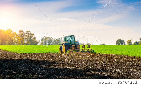 Tractor farm. Agriculture farm machinery on landscape land field. Farmer machine equipment for crop. Tractor farm fields concept. Tractor farm. Agriculture farm machinery on landscape land field. Farmer machine equipment for crop. Tractor farm fields concept. 85464223