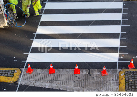 Road painter worker working on zebra crossing of a city street Road painter worker working on zebra crossing of a city street 85464603