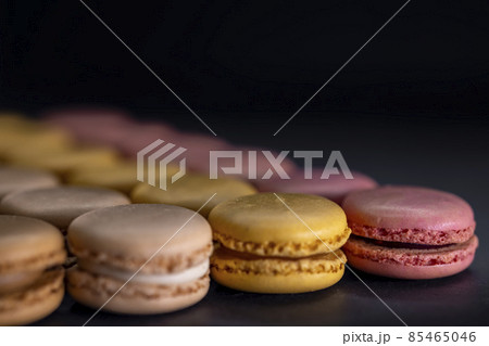chocolate, coffee, vanilla, lemon and strawberry macaroons on black background chocolate, coffee, vanilla, lemon and strawberry macaroons on black background 85465046