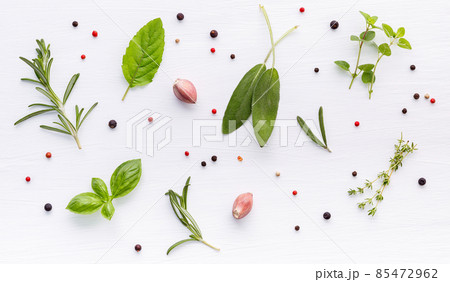 Various of spices and herbs on wooden background. Flat lay spices ingredients rosemary, thyme, oregano, sage leaves and sweet basil on white wooden. 85472962