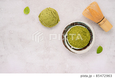 Matcha green tea ice cream with green tea powder and mint leaves setup on white stone background . Summer and Sweet menu concept. Matcha green tea ice cream with green tea powder and mint leaves setup on white stone background . Summer and Sweet menu concept. 85472963