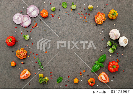 The ingredients for homemade pizza set up on dark stone background. The ingredients for homemade pizza set up on dark stone background. 85472967