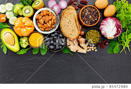 Ingredients for the healthy foods selection. The concept of healthy food set up on dark stone background. Ingredients for the healthy foods selection. The concept of healthy food set up on dark stone background. 85472980