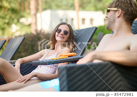 Cute young couple in sunglasses having good time together 85472981