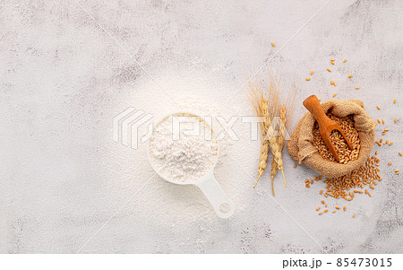 The ingredients for homemade pizza dough with wheat ears ,wheat flour and olive oil set up on white concrete background. top view and copy space. 85473015