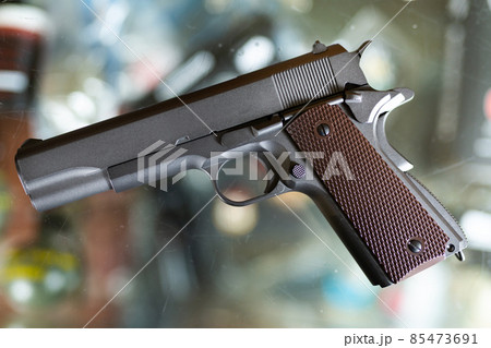Pistol on showcase in weapon shop 85473691