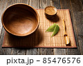 Empty wooden bowl on natural background. 85476576