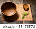 Empty wooden bowl on natural background. 85476578
