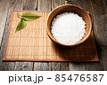 Wooden bowl with salt on natural background. 85476587