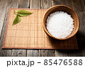 Wooden bowl with salt on natural background. 85476588