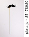 Black moustache shape paper die cut selfie portrait party fun paper prop sticker stick on white background  85478980