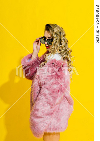 Gorgeous young woman posing in luxurious fur coat and bodysuit. Fashion, beauty. Studio shot. 85480933