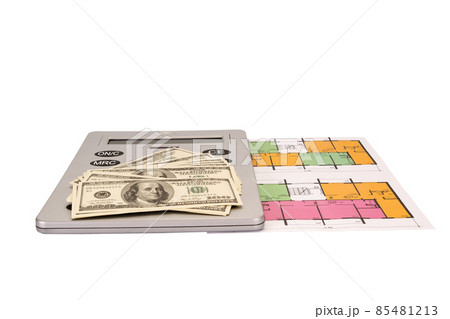 Hundred dollar bills money pile and and calculator on blueprints with an architecture model 85481213