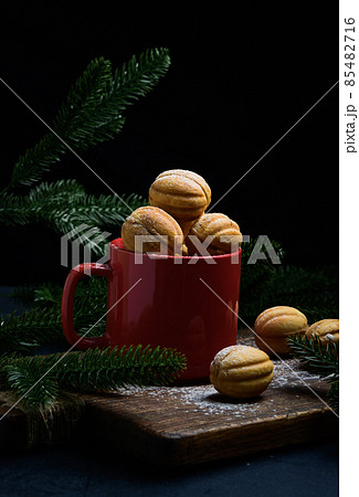 baked nut-shaped dessert in a red ceramic mug baked nut-shaped dessert in a red ceramic mug 85482716