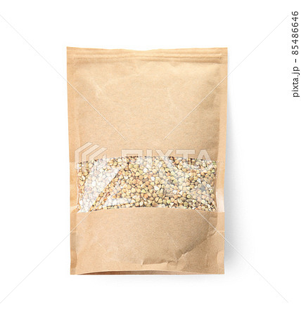 Uncooked green buckwheat grains in package isolated on white, top view. Mockup for design Uncooked green buckwheat grains in package isolated on white, top view. Mockup for design 85486646