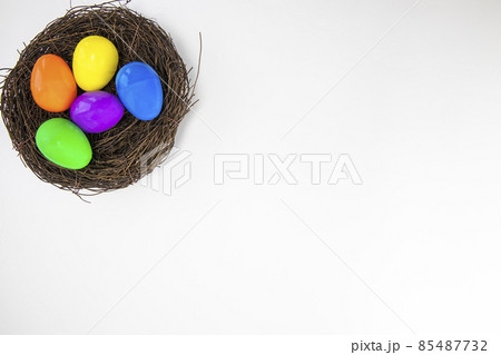 Colorful painted Easter Eggs isolated on white background with nest.Top view Happy Easter Holiday copy space Colorful painted Easter Eggs isolated on white background with nest.Top view Happy Easter Holiday copy space 85487732
