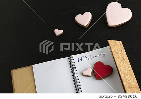Handwritten notebook with 14 FEBRUARY and heart-shaped cookies. Valentines Day. Handwritten notebook with 14 FEBRUARY and heart-shaped cookies. Valentines Day. 85488016