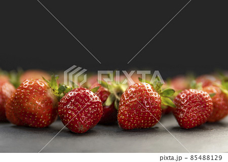 Close up ripe juicy strawberries on black background. Place for your text. Copy space. 85488129