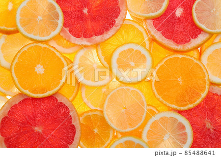 Slices of fresh tangerines and different citrus fruits on white background, top view 85488641