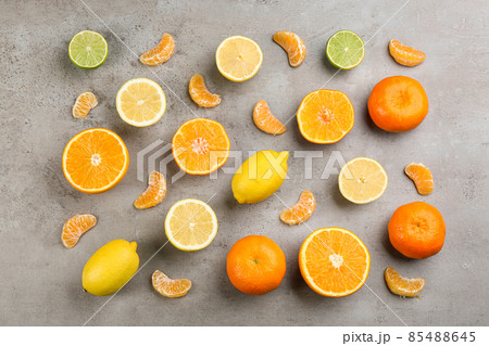 Flat lay composition with tangerines and different citrus fruits on grey background 85488645