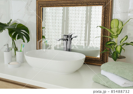 Vintage mirror and vessel sink in stylish bathroom 85488732
