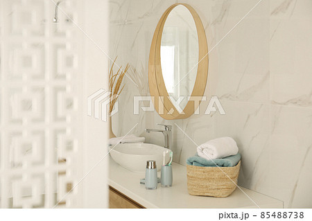 Round mirror over vessel sink in stylish bathroom interior 85488738
