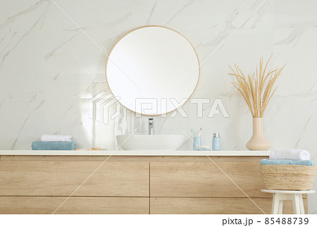 Round mirror over vessel sink in stylish bathroom interior 85488739